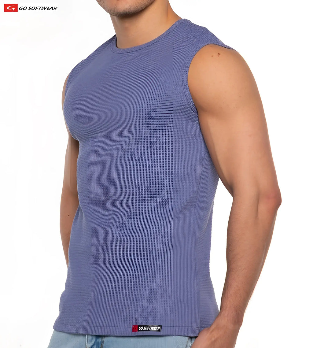 A men’s medium blue ribbed sleeveless tank top with round neckline and go softwear label at the bottom hem