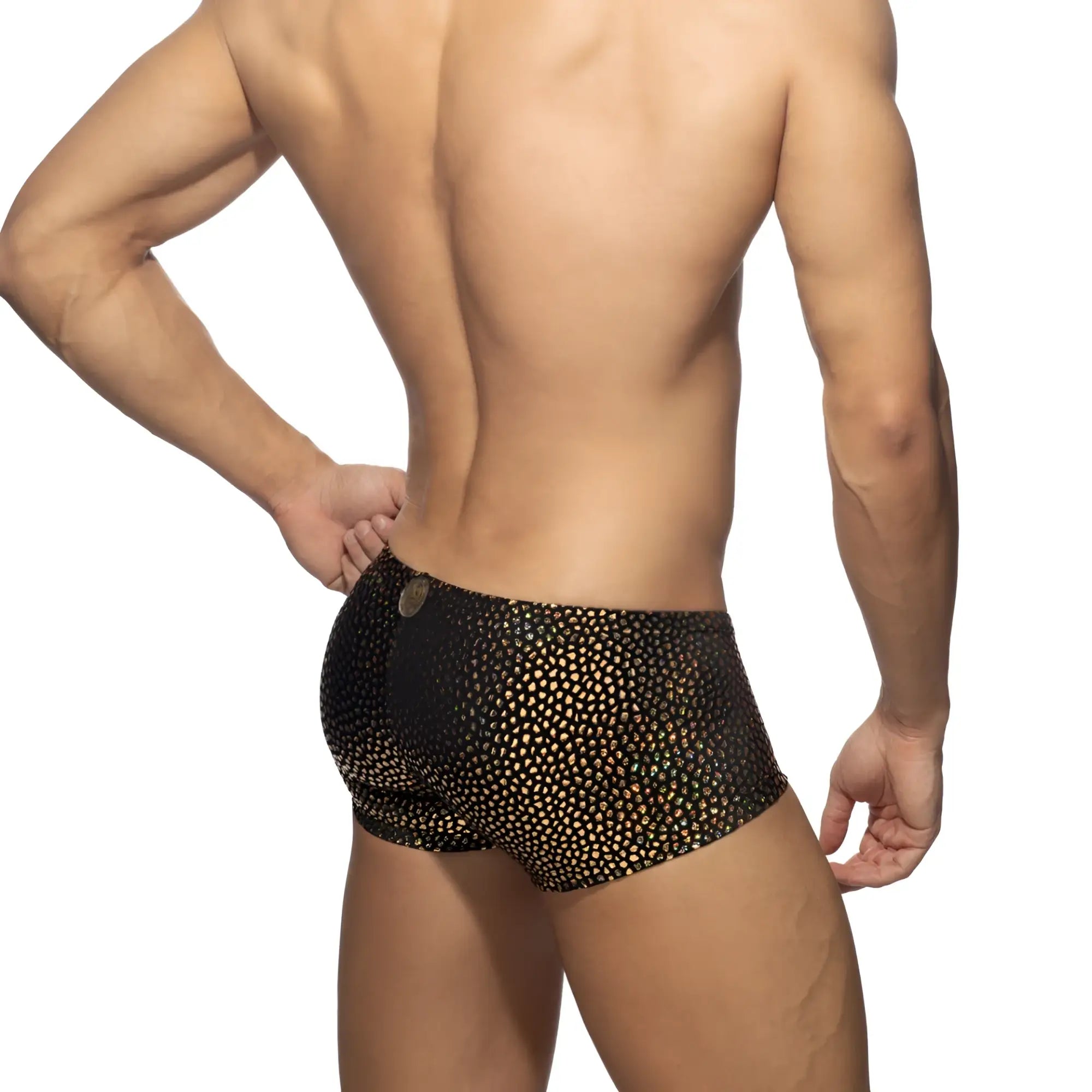 Black swim trunks with shimmering gold dot pattern featuring breathable quick-dry fabric for beachwear
