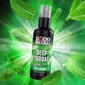Good Blow Deep Throat Spearmint numbing spray bottle centered against a vibrant, exploding green mint leaf background.