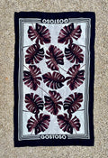 Navy blue and white gostoso canga de praia beach towel with bold maroon monstera leaf pattern for Brazilian beachwear