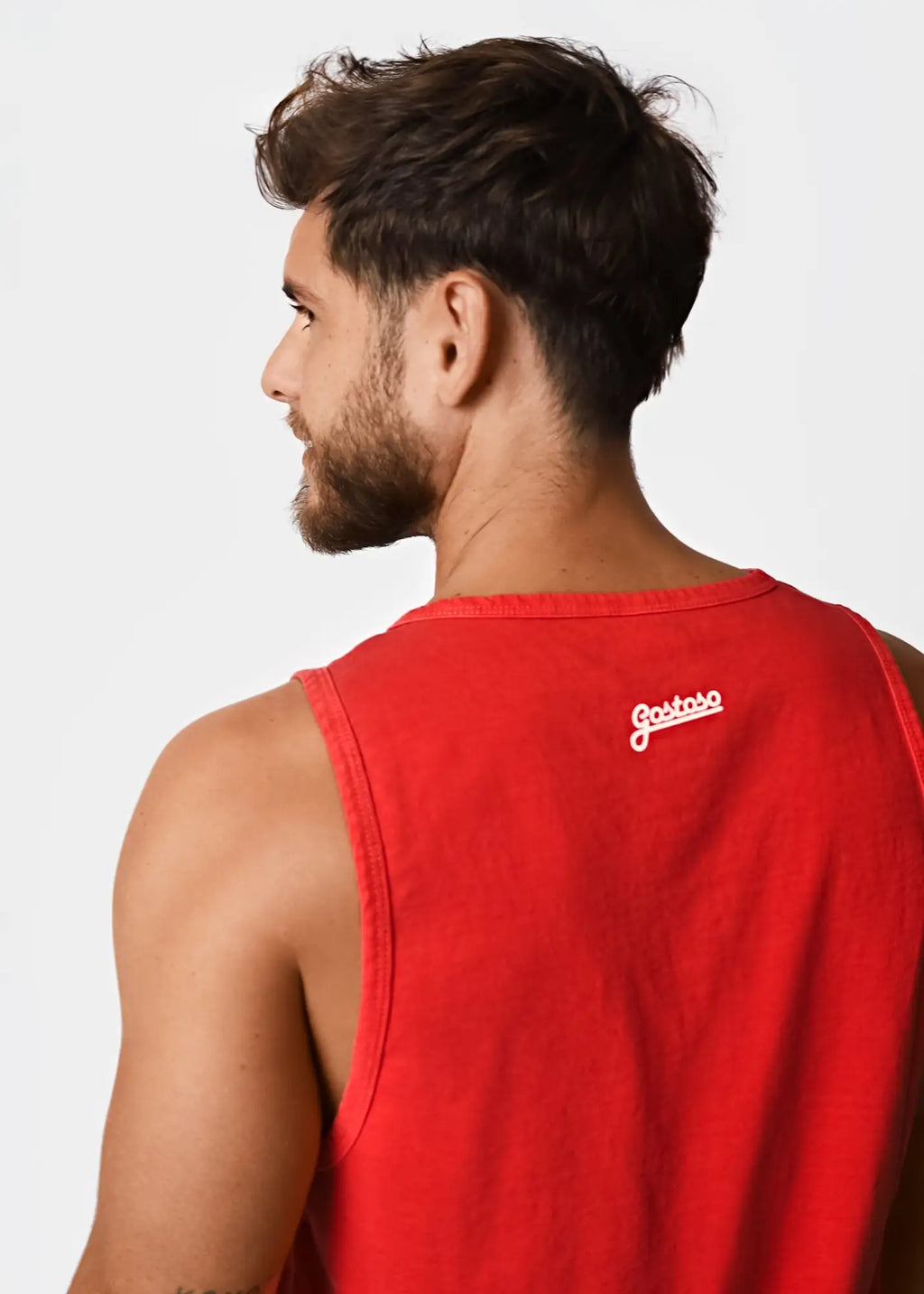 Back view of gostoso red tank men’s sleeveless cotton tank top with white cursive logo on the back