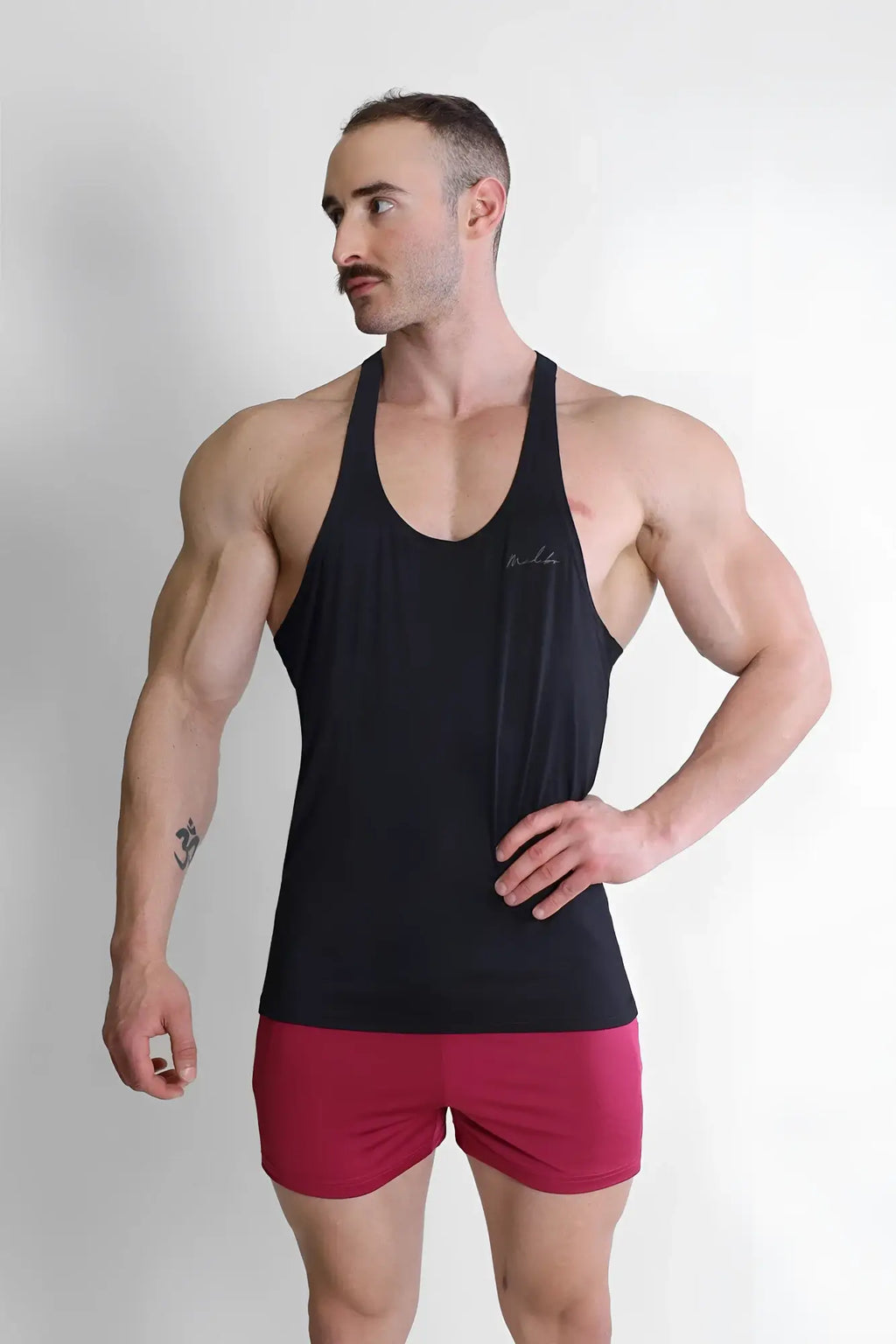 Black sleeveless athletic tank top gym bae classic workout stringer with subtle embroidered logo on chest