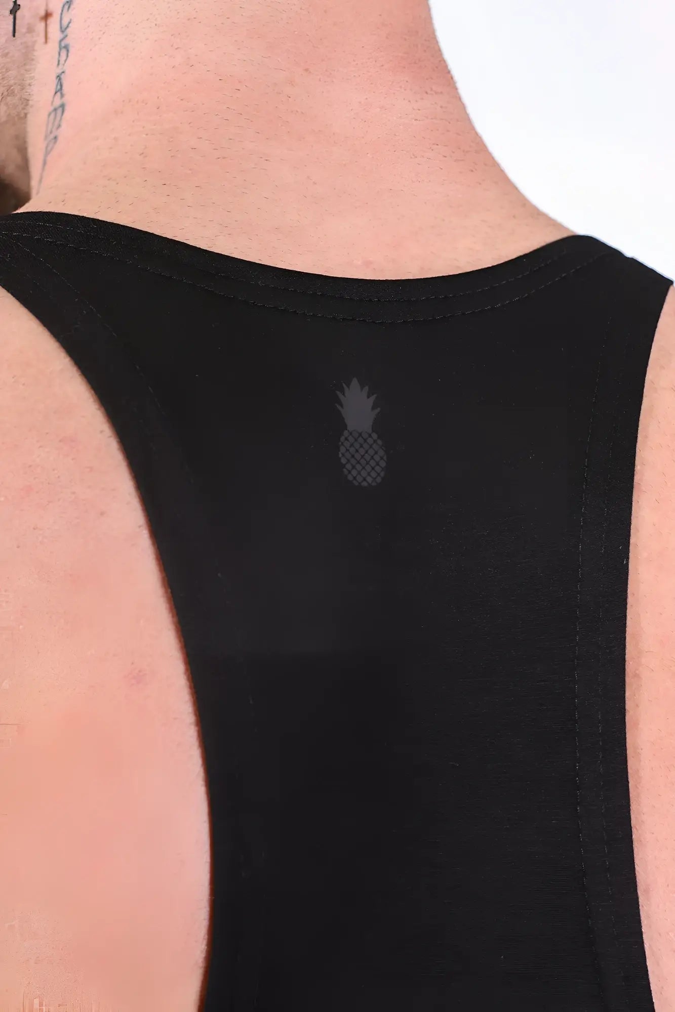 Back view of gym bae classic workout stringer sleeveless black tank top with subtle gray pineapple logo