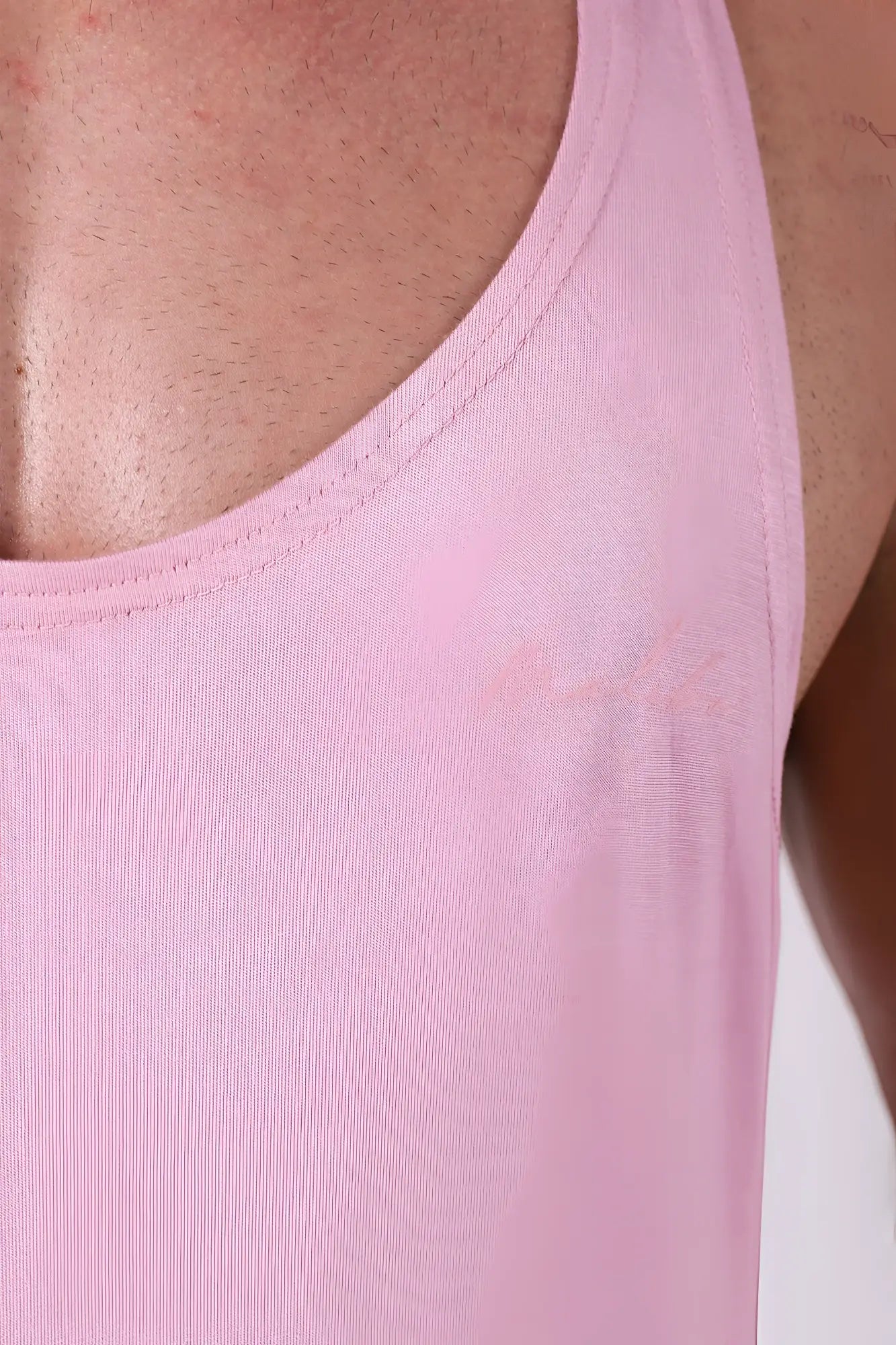 A soft pink ribbed cotton gym bae classic workout stringer tank top with a simple round neckline