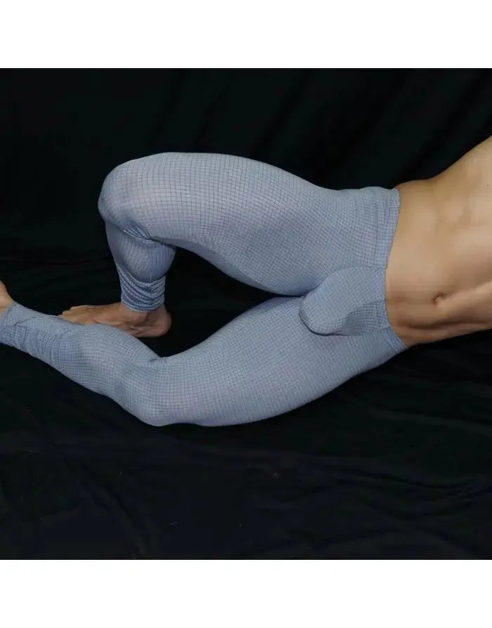 Light blue men's gym tights with a fitted design featuring a bulge pouch shown on a model by Arroyman.