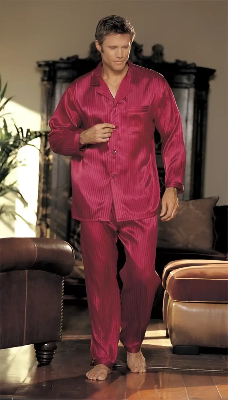 A man wearing a shiny deep red satin pajama set with subtle vertical stripes from gyz silky soft stripe collection size s