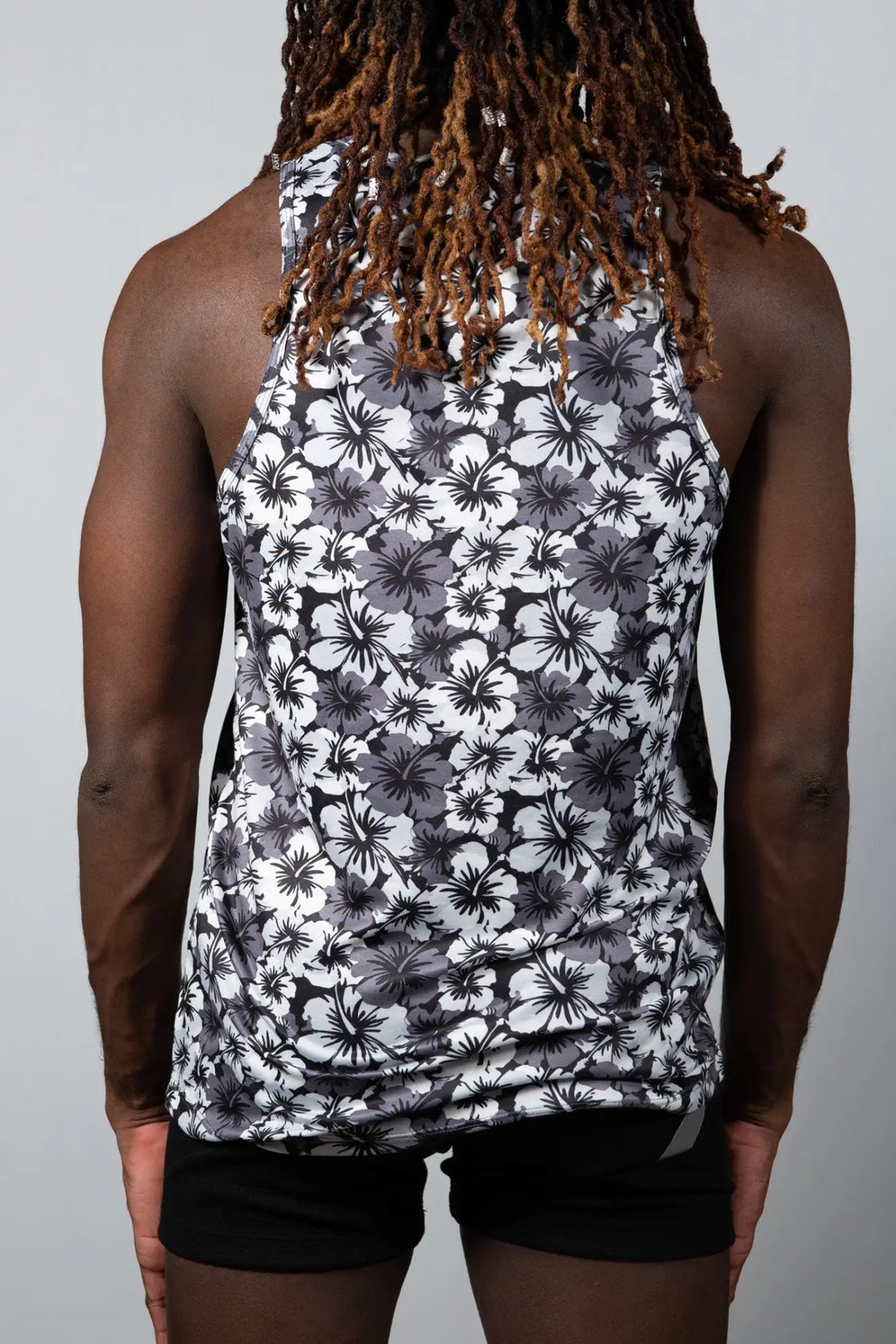 A black and white floral print sleeveless fitted tank top with a hawaiian hibiscus design