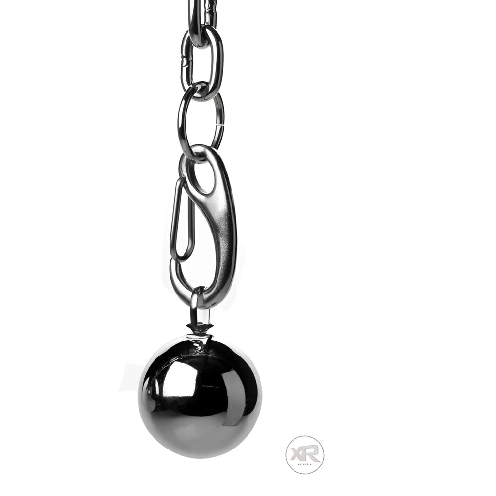 A sleek black spherical heavy hitch ball stretcher hook with weights hangs from a silver-toned chain and carabiner clip