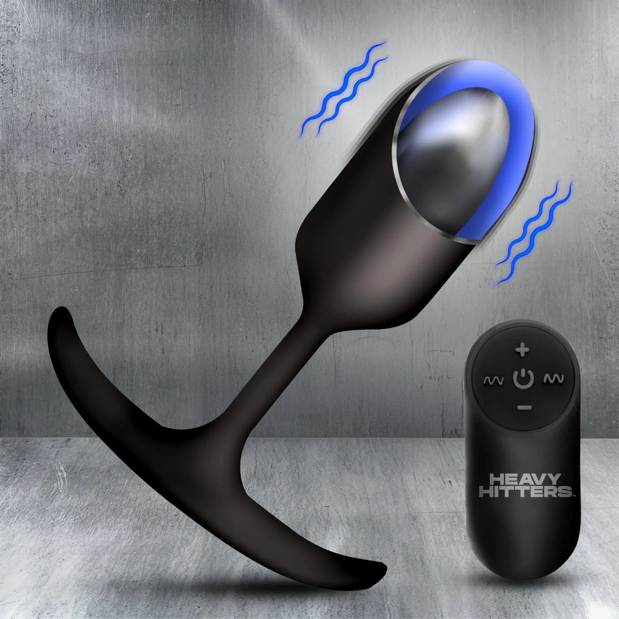Heavy Hitters black silicone vibrating anal plug with a glowing blue light and matching remote on a metallic background.