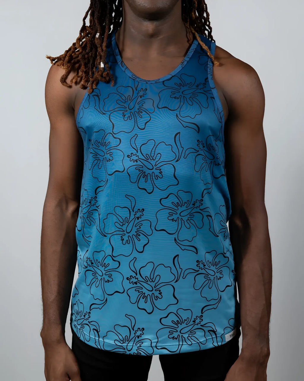 Blue floral-patterned tank top with black outlined hibiscus flowers in hibiscus ombre print tank design