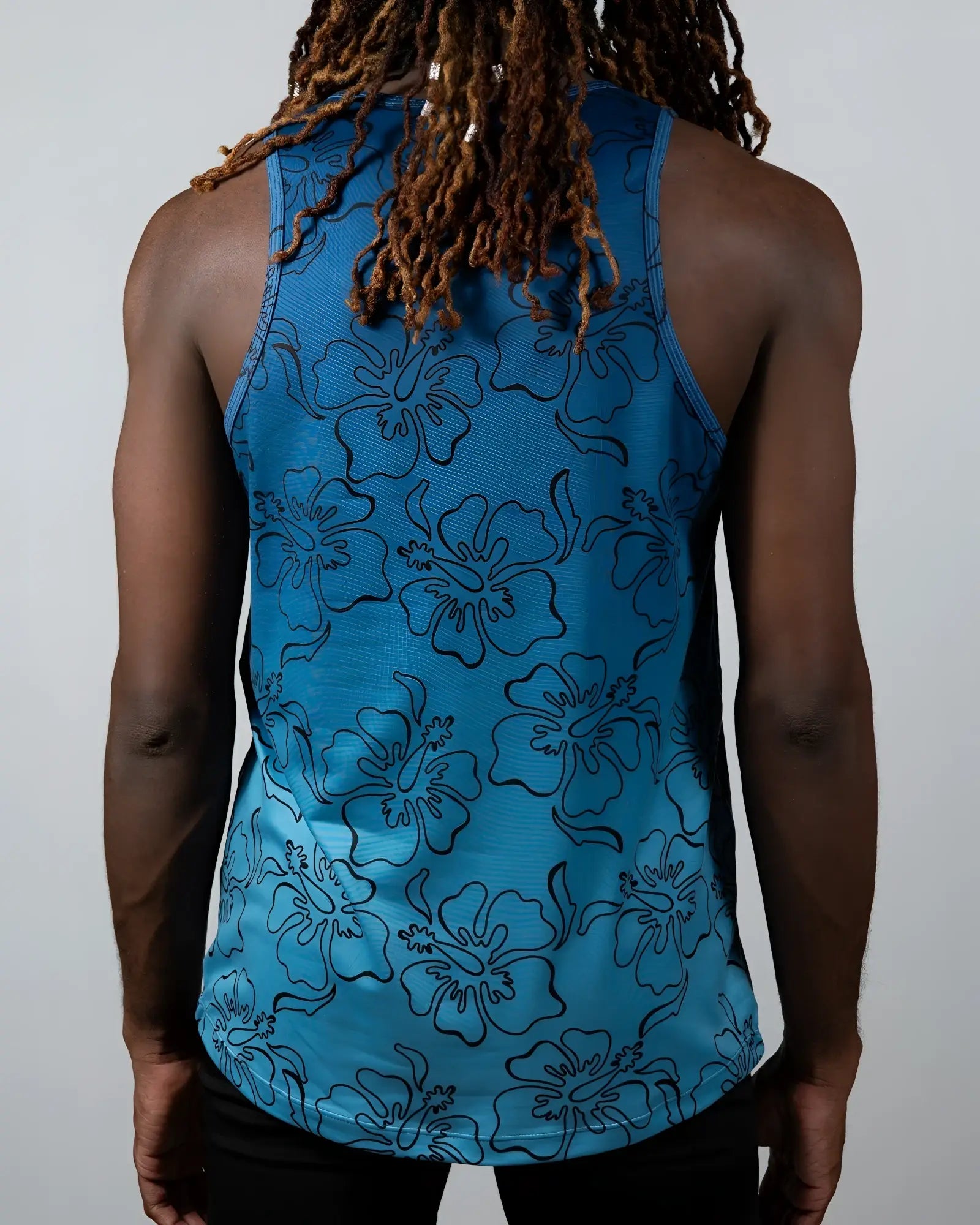 Blue floral-patterned tank top with black outlined hibiscus flowers from hibiscus ombre print tank collection