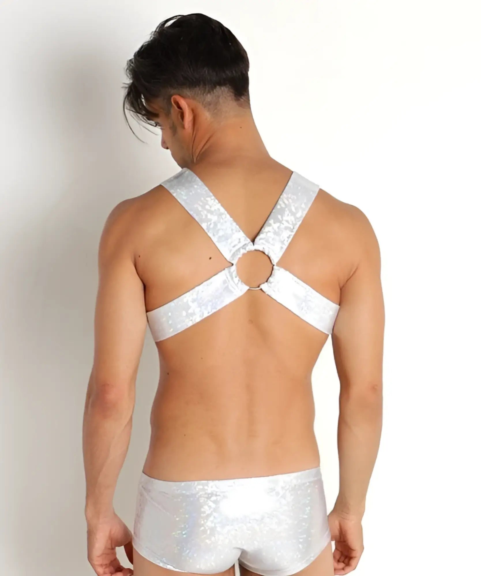 Silver sequined hologram harness top with central circular ring and matching shiny briefs for bold festival wear