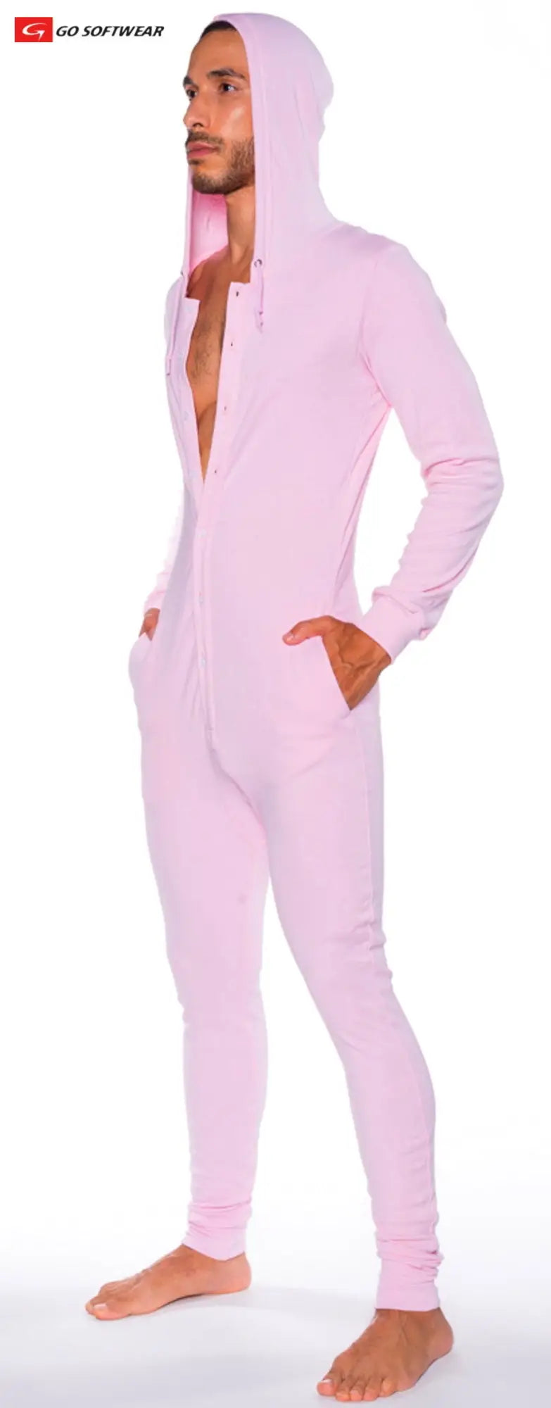 A man wearing a pink hooded union suit with pockets featuring long sleeves and full-body coverage
