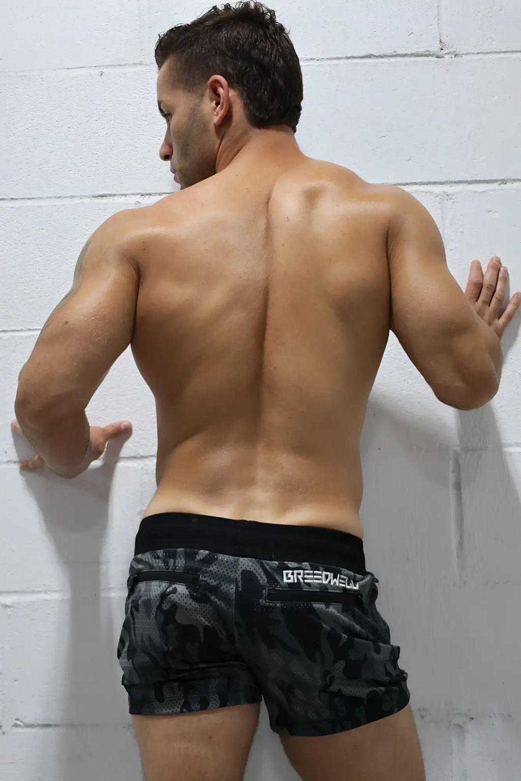 Hook up shorts are black and gray camouflage athletic shorts with a black waistband featuring breedwell branding