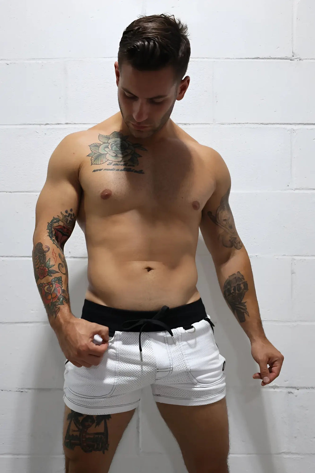 White hook up shorts with mesh material and black drawstring waistband for breathable athletic wear