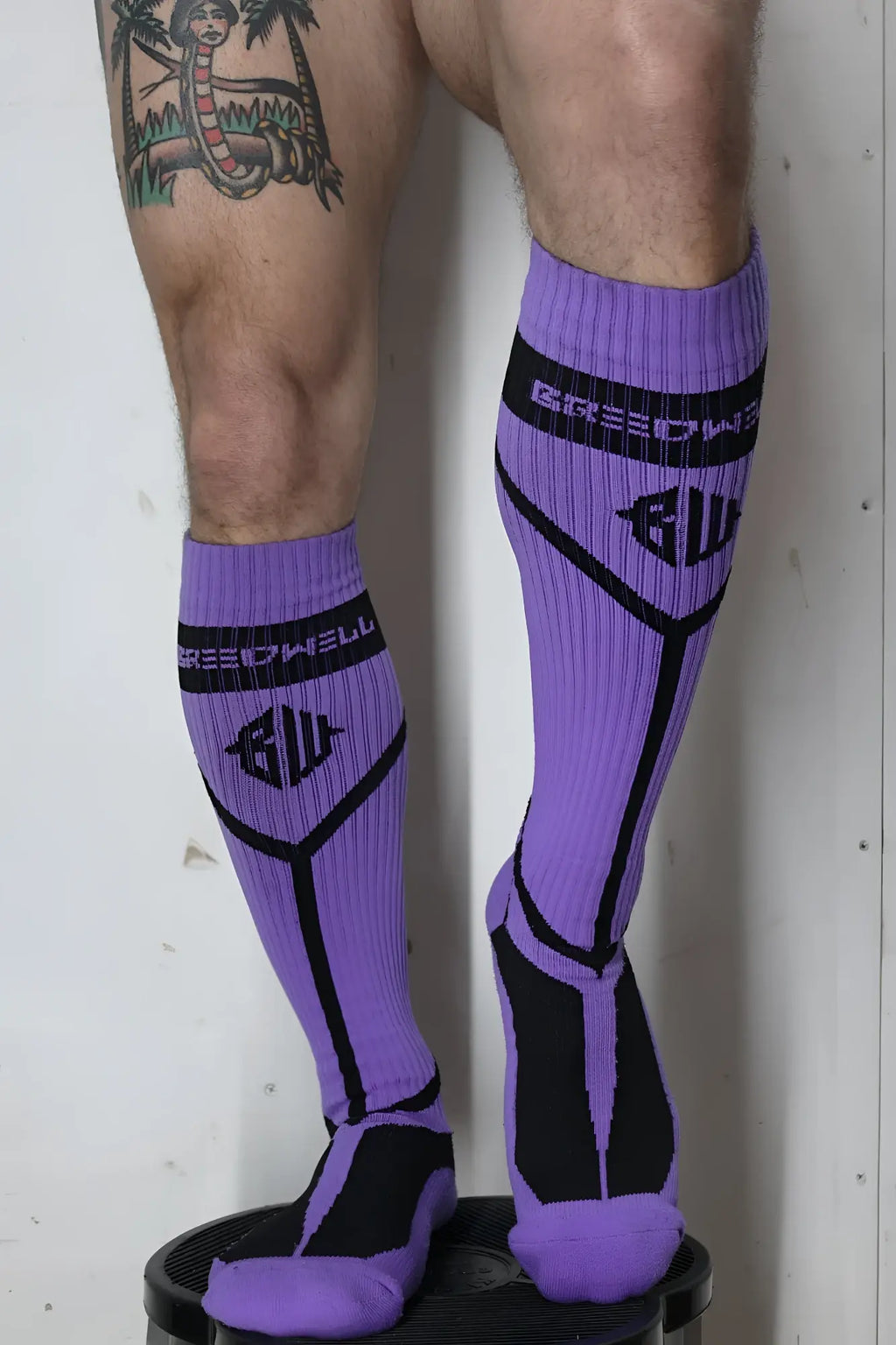 Purple and black hook up athletic compression socks with ribbed texture and bold geometric design by speedwell
