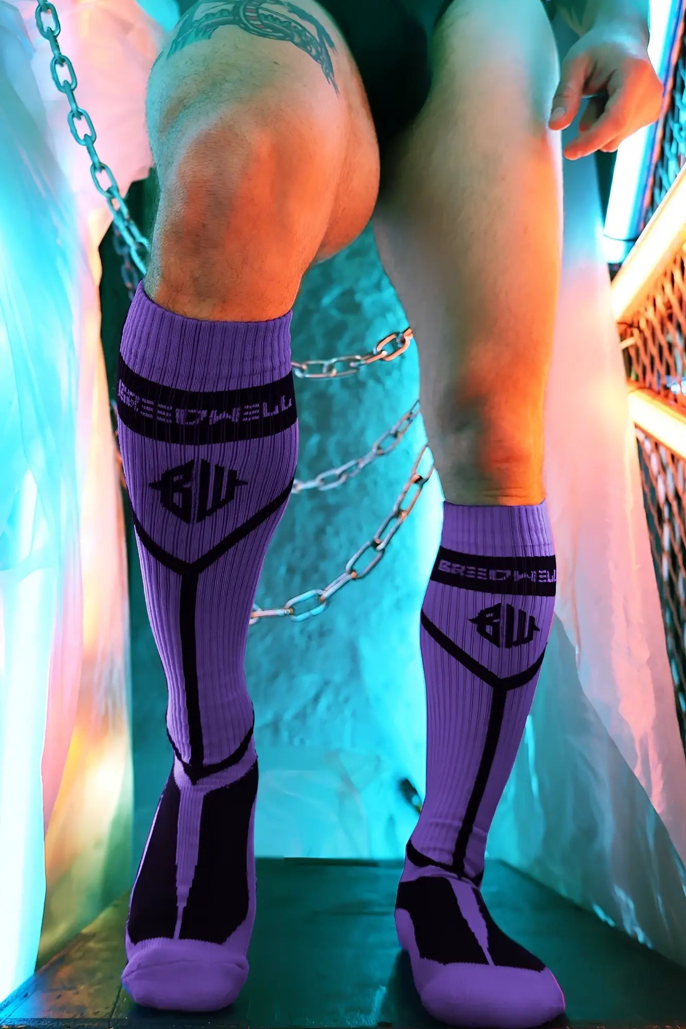 Purple and black athletic knee high socks with bold geometric design and breedwell logo in hook up socks purple product