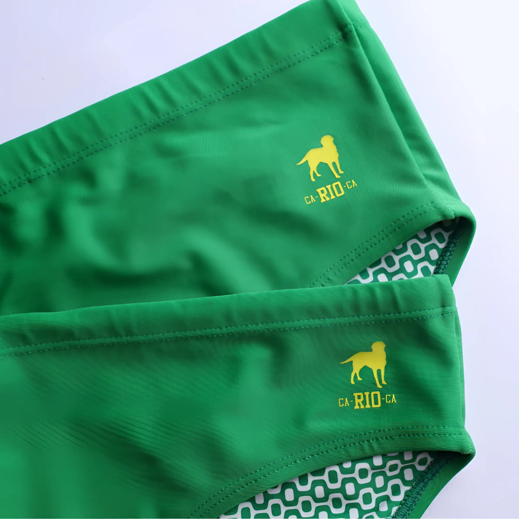 Hortelã green solid men’s swimming sunga featuring green swim trunks with yellow dog and ca-rio-ca embroidery on waistband