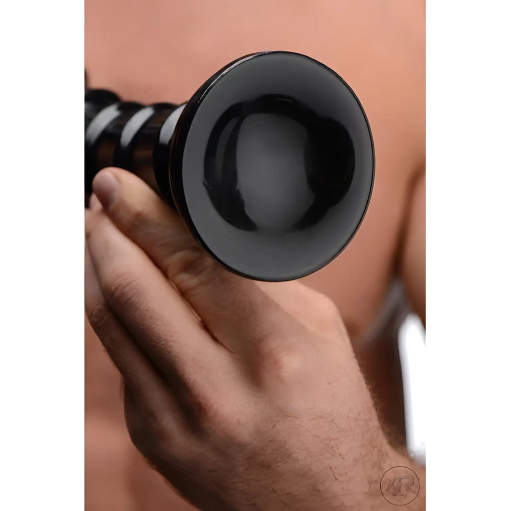 A hand holds an 18-inch black Hosed Swirl Thick Anal Snake with a smooth flared base and a spiraled, textured shaft.