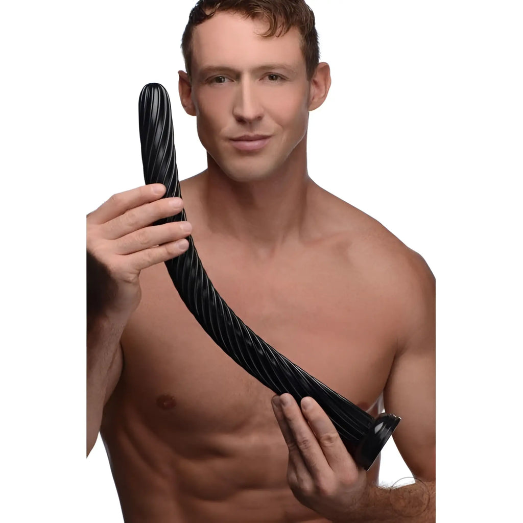 A shirtless man holds a long, black, 19-inch Hosed anal snake with a flexible, spiraled ribbed texture.