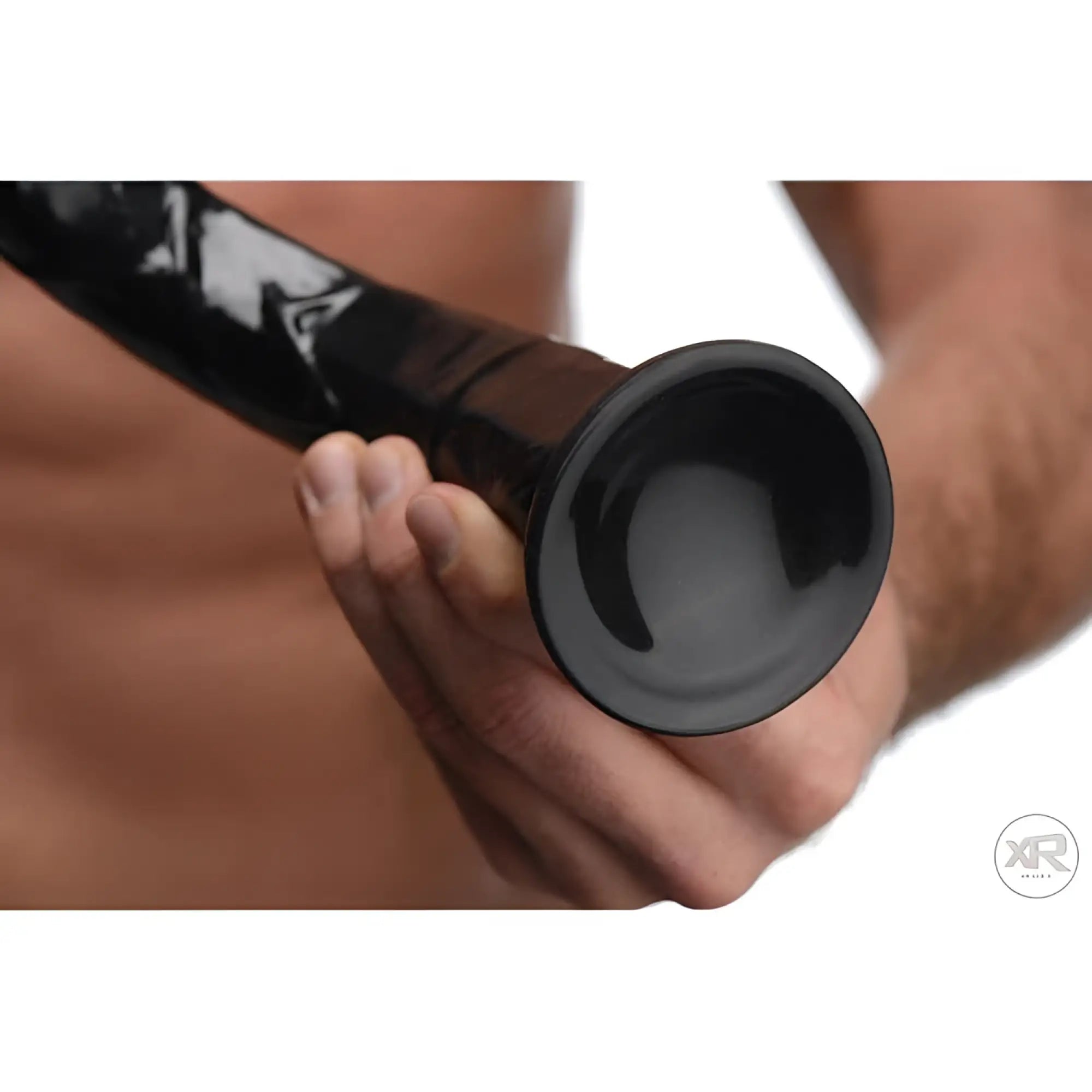Hosed Hosed 19-inch realistic black anal dildo with a flared base, held in a hand.