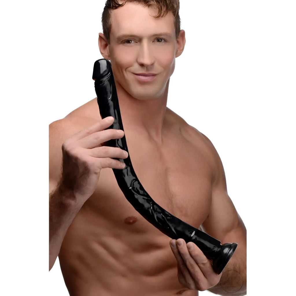 A shirtless man holding a 19-inch black, realistic Hosed anal dildo against a plain white background.