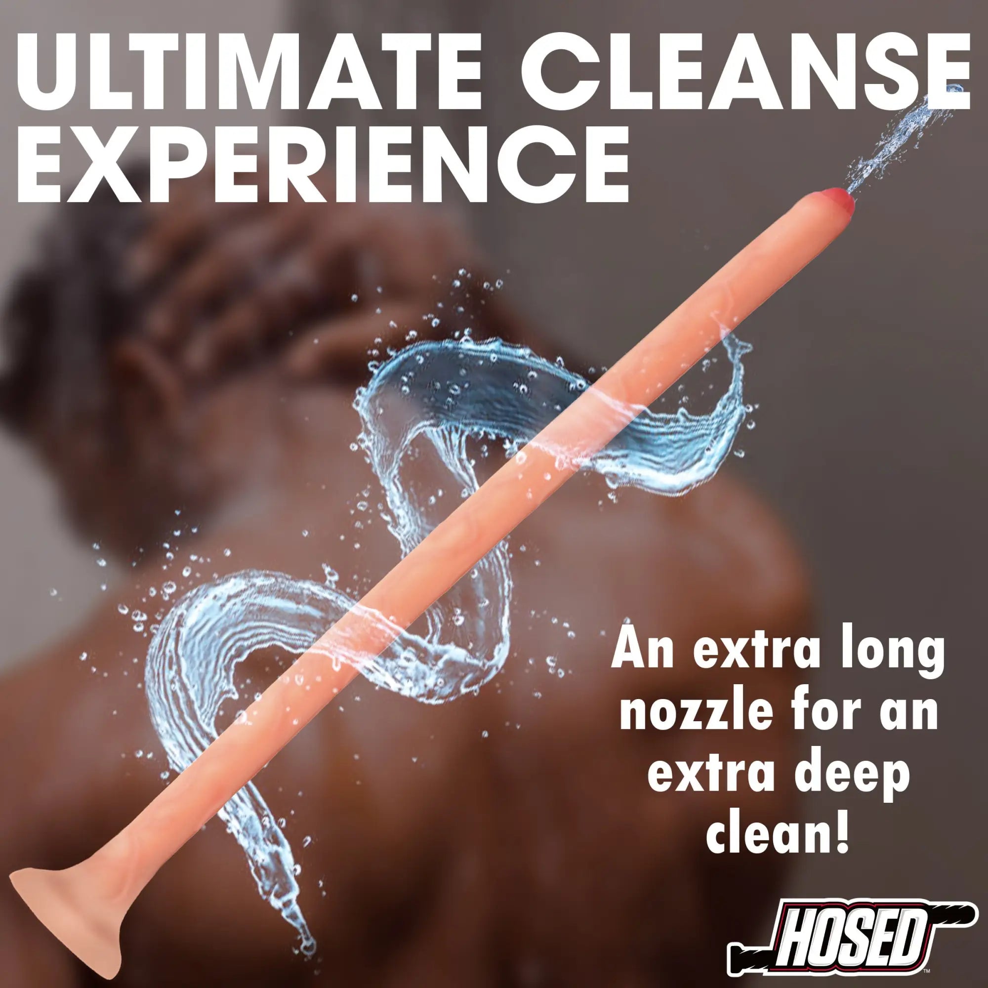 Hosed 19" Uncircumcised Slim Silicone Enema Hose: A long, tan, thin silicone nozzle spraying water in a shower setting.