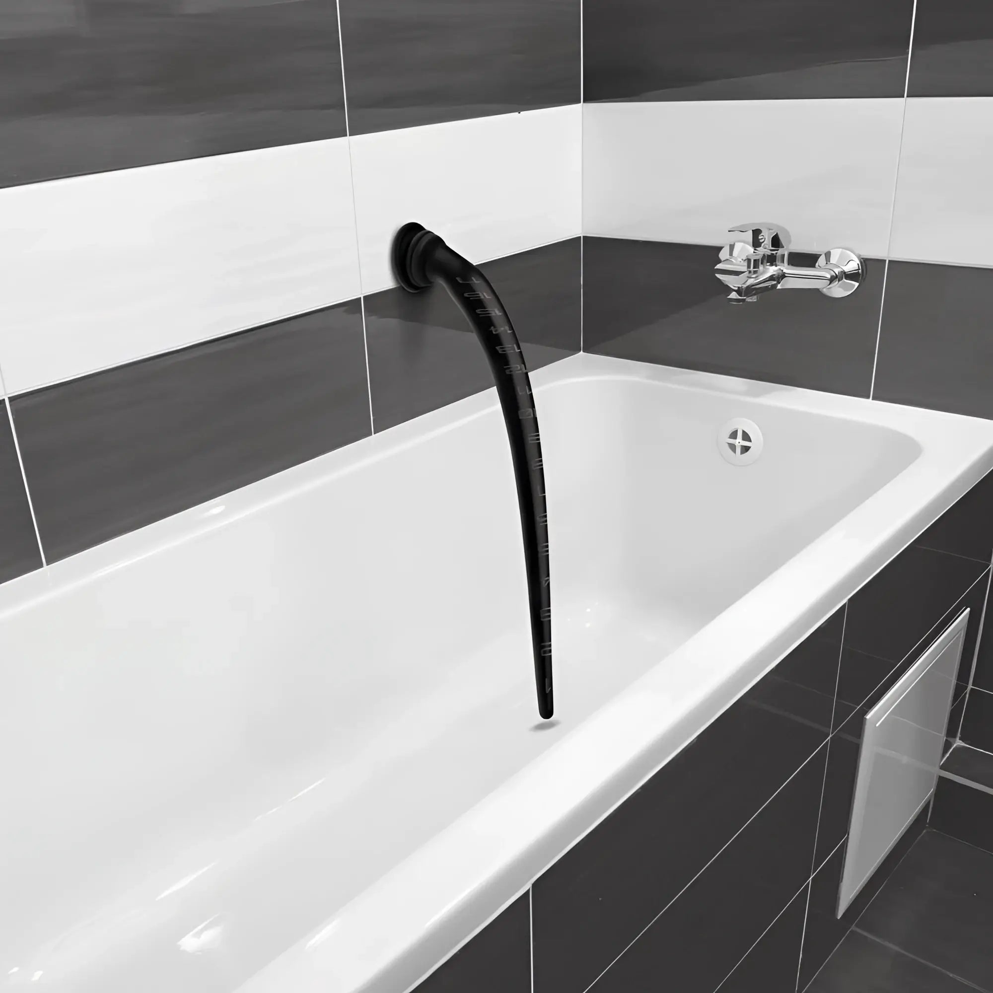 Black, tapered silicone anal hose with depth markings, mounted to a tiled bathroom wall above a white bathtub.