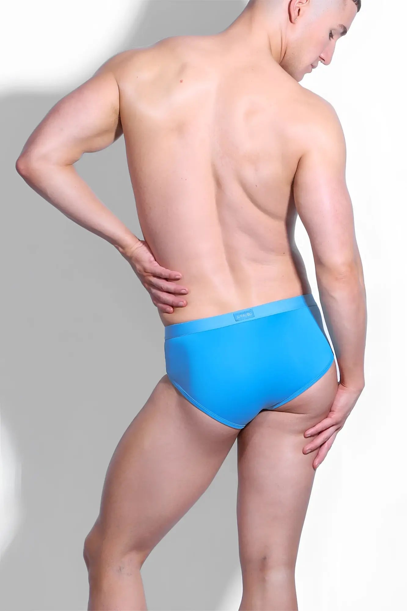 Bright blue smooth-fitting hustler cross briefs for men with a subtle brand tag at the waistband