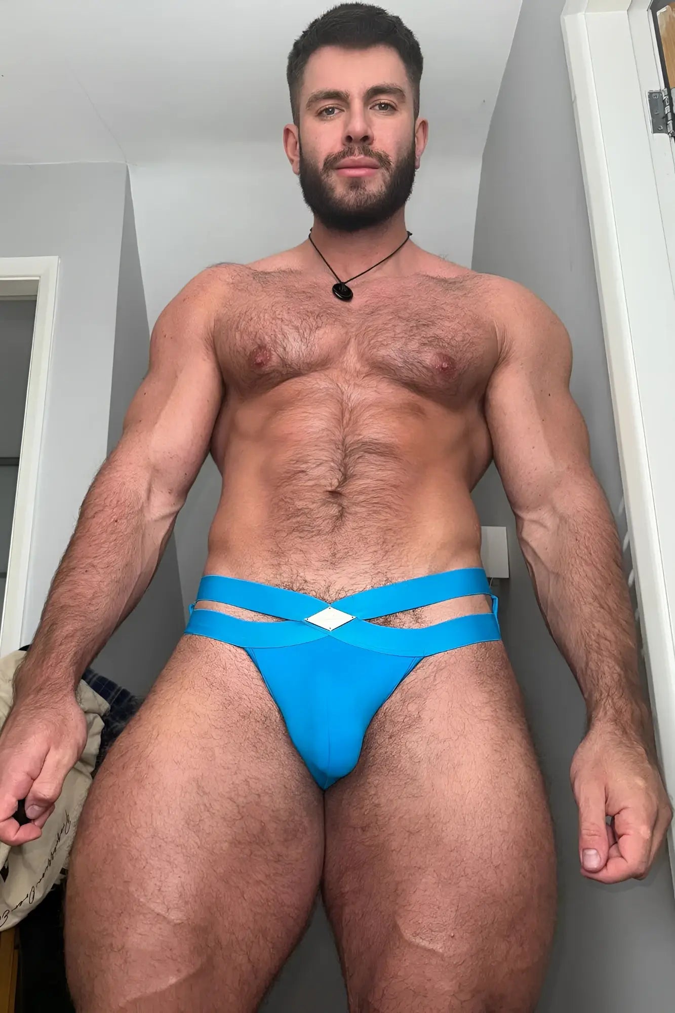 Bright blue hustler cross briefs with strappy design and white diamond-shaped accent at the front