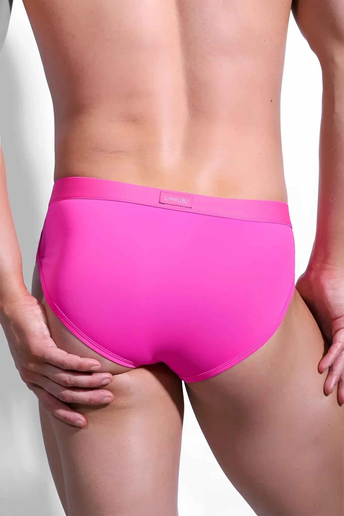 Bright pink Hustler Cross Briefs men’s briefs with smooth seamless fabric and subtle brand tag at the waistband
