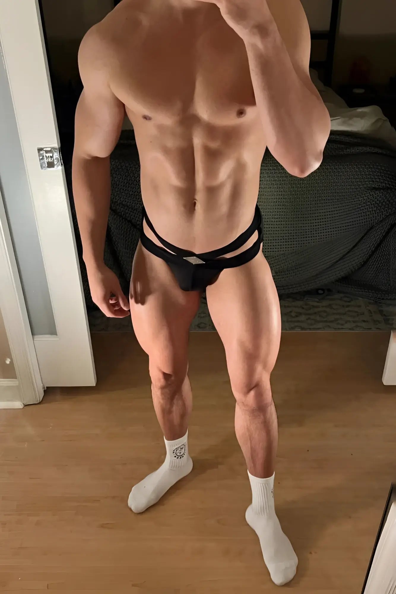 Black strappy athletic briefs with central cutout design in obsidian black for activewear and comfort