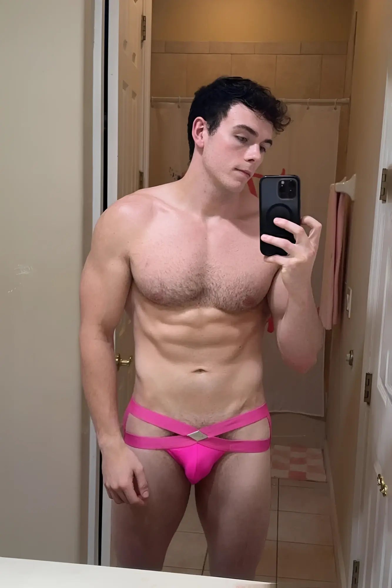 Bright pink hustler cross jockstrap briefs with strappy athletic cut and diamond shaped metallic accent at front
