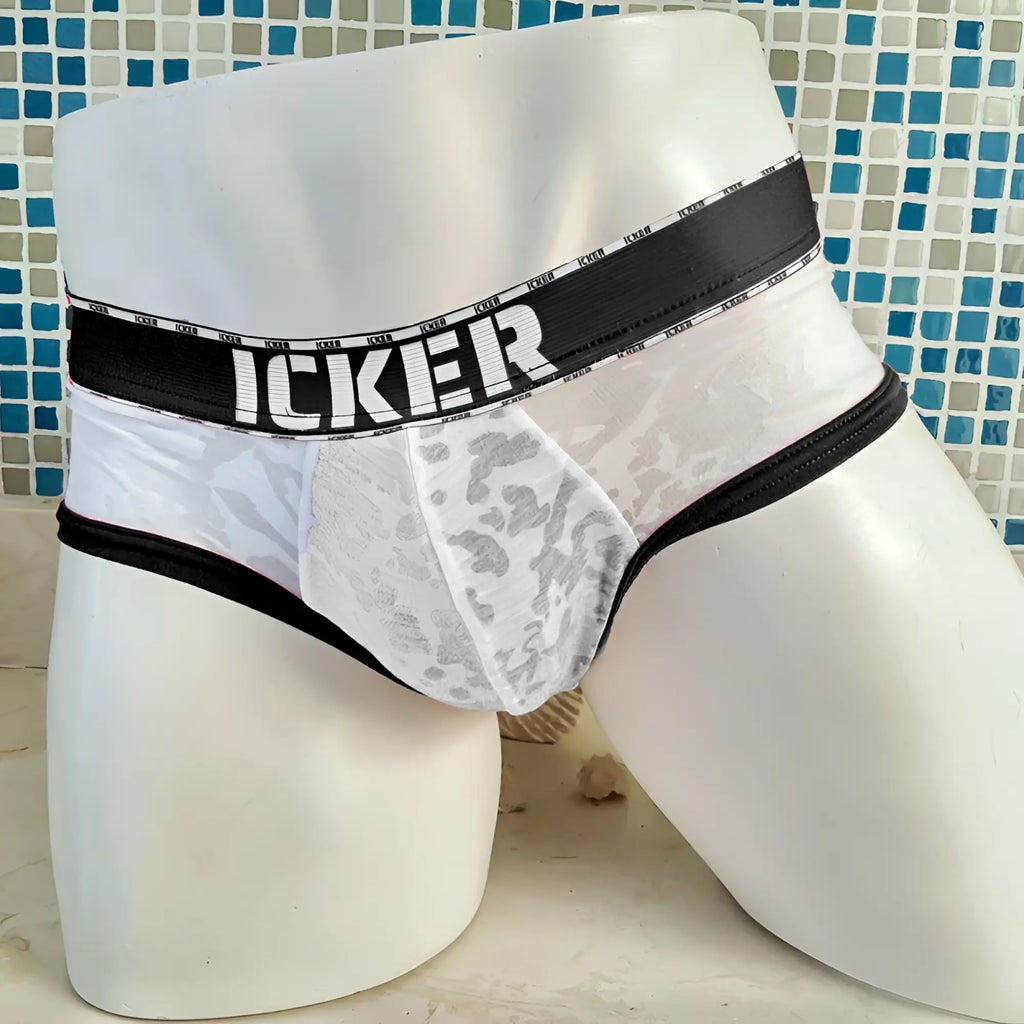 White lace-trimmed mesh briefs with black waistband featuring icker brand name bold lettering in black coI-21-02