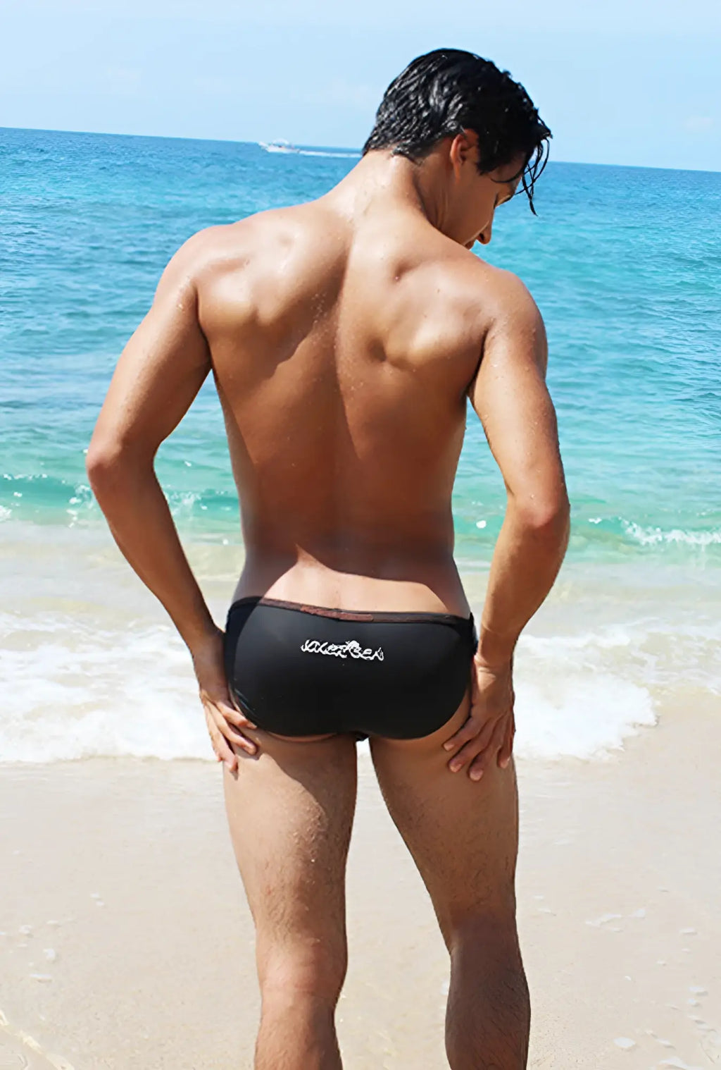 Black icker sea contrast stitching micro slip tanga bikini swimwear showing back with subtle white logo on swim trunks