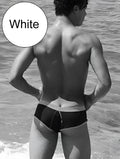 White swim trunks with black contrast trim and stitching from icker sea cheeky mini bikini swimwear collection