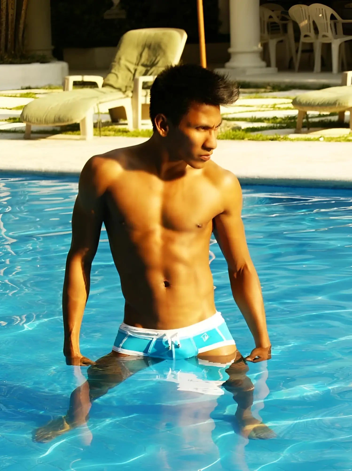 A man standing in a pool wearing icker sea cord contrast trim and stitching bikini swimwear in blue and white