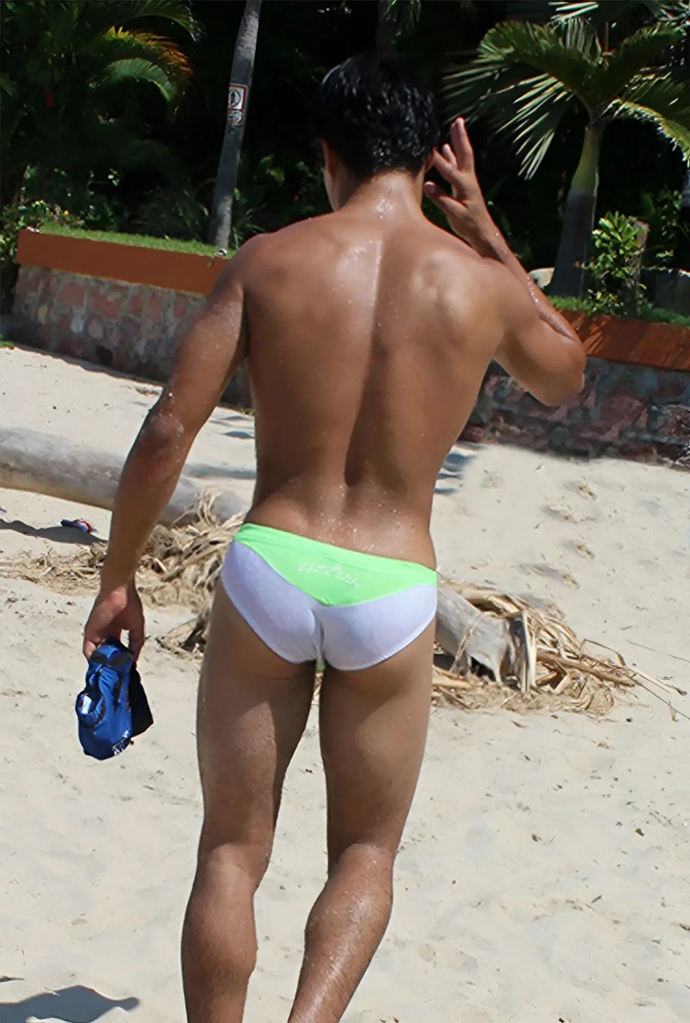 The back side of icker sea duotone bikini swimwear green cob-15-22 swim trunks with lime green waistband and fabric print