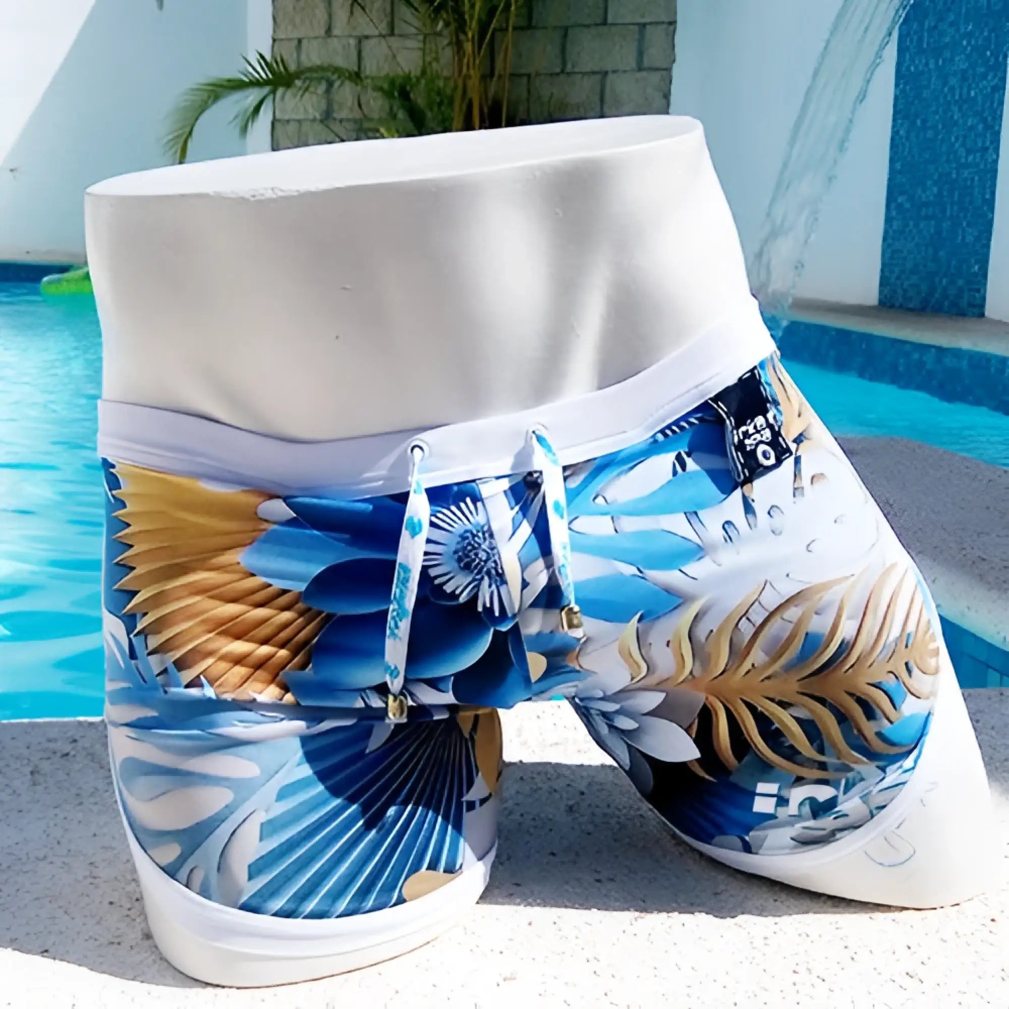 Icker Sea Greek Floral open side suspender scalloped shorts swimwear in blue and gold tropical print with white waistband