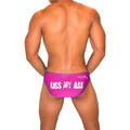 Vibrant pink jaxx men’s briefs with bold white kiss my ass text and dark contrast stitching in fuchsia bikini style