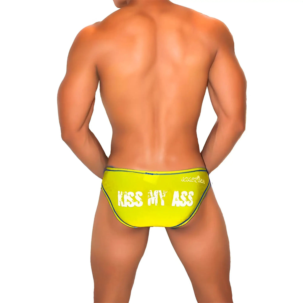 Vibrant neon yellow Icker Sea Kiss My Ass swim trunks with bold white text and black trim for beachwear