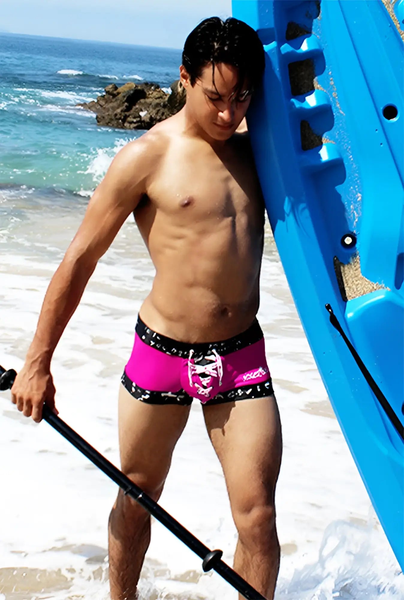 Bright pink fuchsia icker sea lace up contrast square cut trunk swimwear with black trim and white skull design