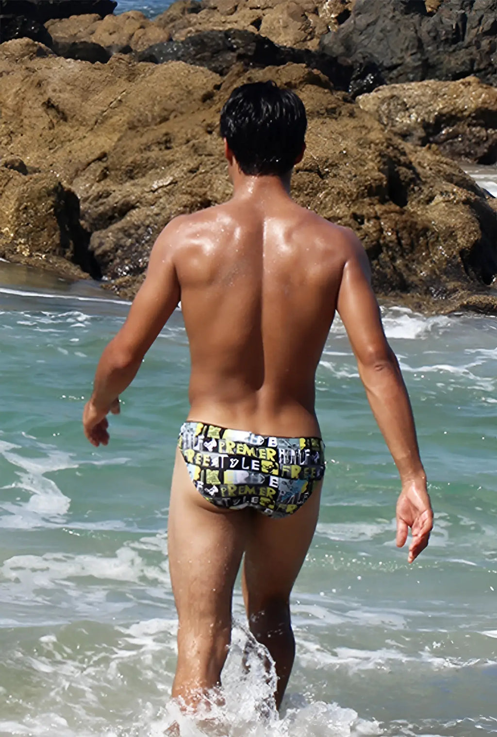 Icker Sea Letters bikini swimwear swim trunks with bold black and yellow graphic lettering on a dark background