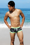 Icker Sea letters square cut trunk swimwear in black and neon green with white graphic print for swimming