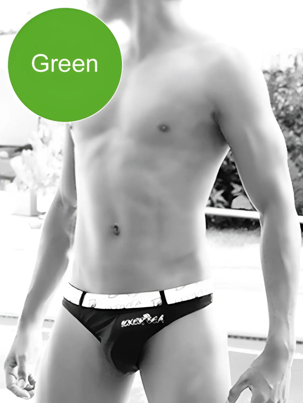 Black briefs with white waistband featuring exotica branding, paired with icker sea sailor green belted tanga thong swimwear