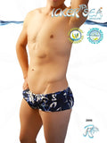 Blue and white patterned swim trunks with tropical design featuring Icker Sea brand logo in Brazilian square cut style