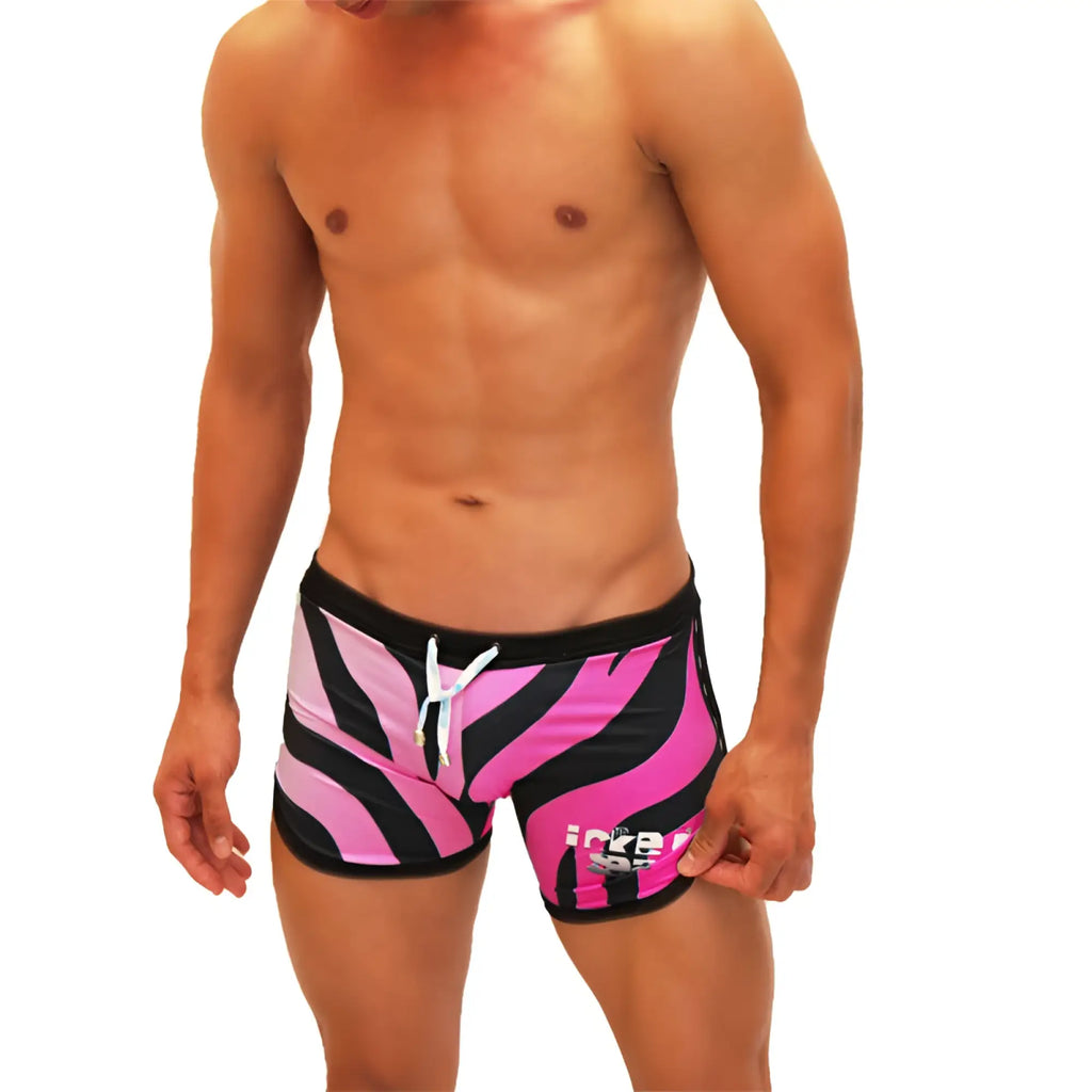 Vibrant pink and black zebra-striped swim trunks with white drawstring from icker sea zebra open side scalloped shorts