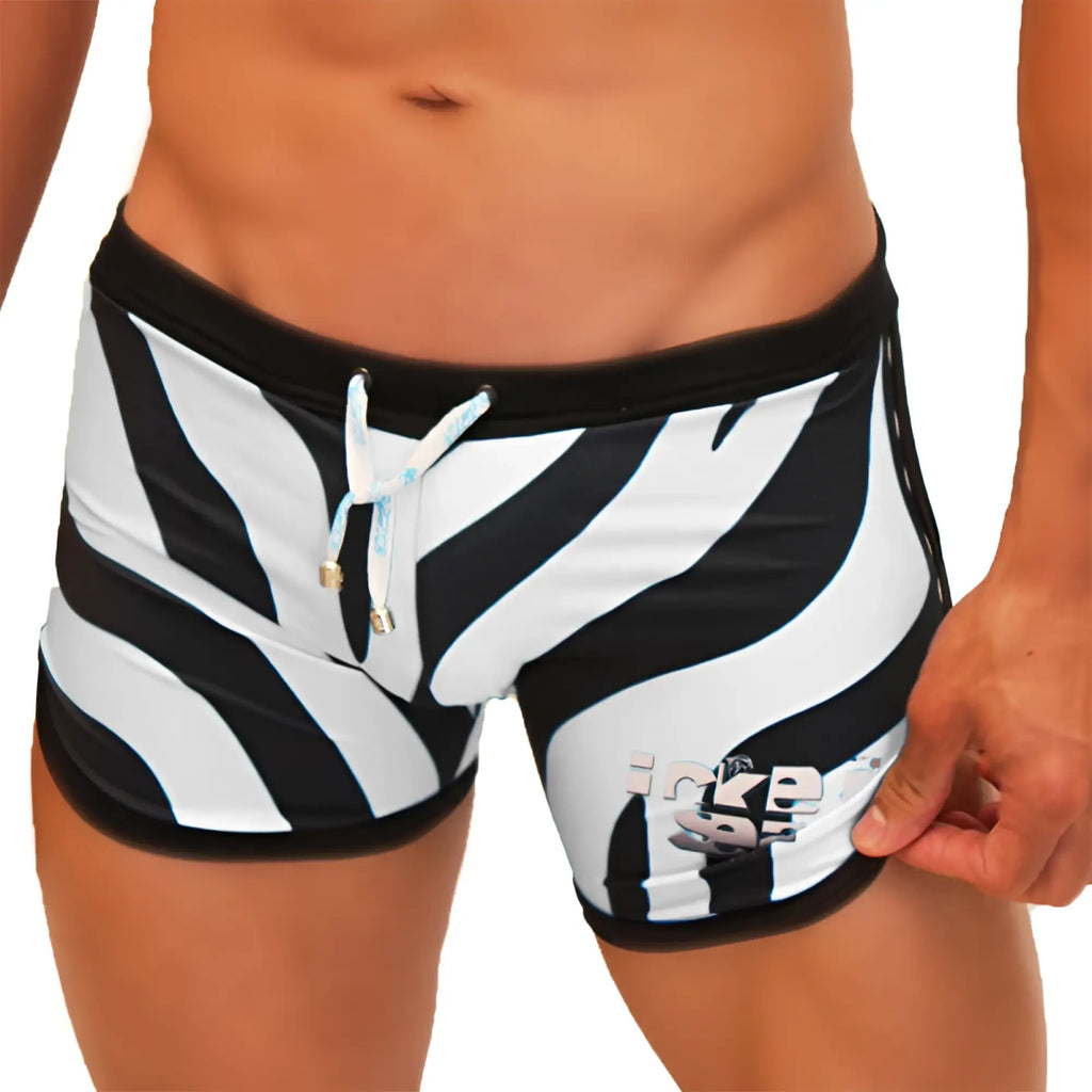 Icker Sea zebra open side suspender scalloped swim trunks with black waistband, light blue ties, and zebra stripes
