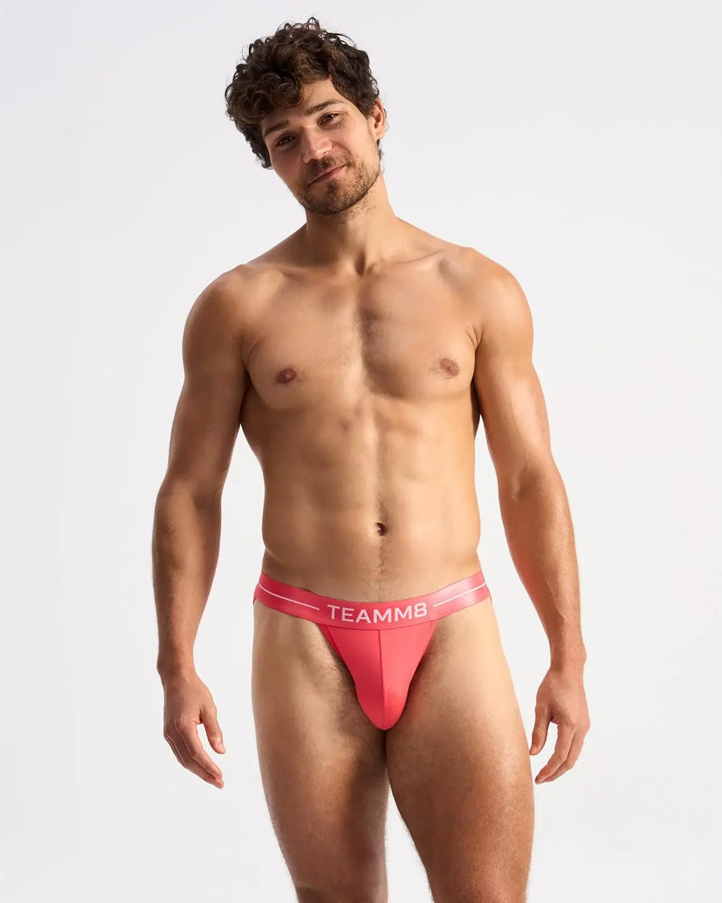 Vibrant coral-colored teammb icon sports brief with sleek form-fitting design for active performance