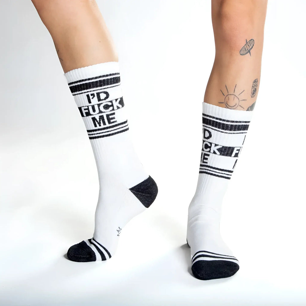 White crew socks with black text id fuck me and matching black stripes toe caps and heel accents